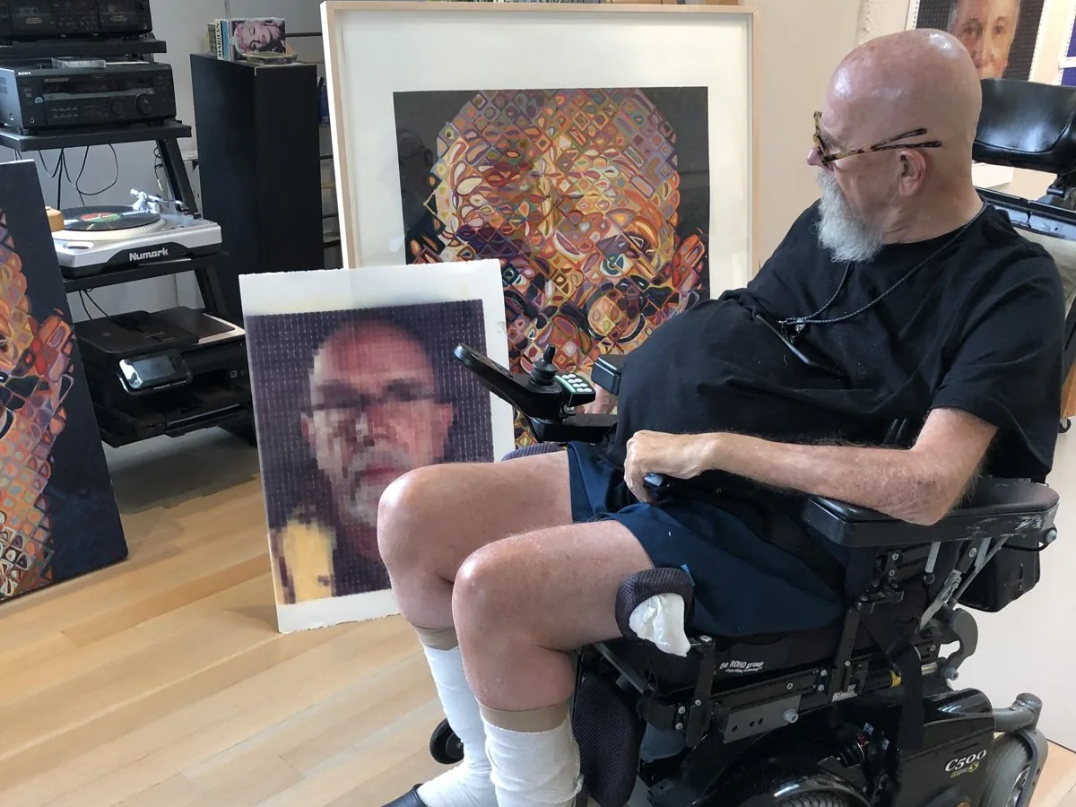 Chuck Close in his studio with large portrait prints made at Matr